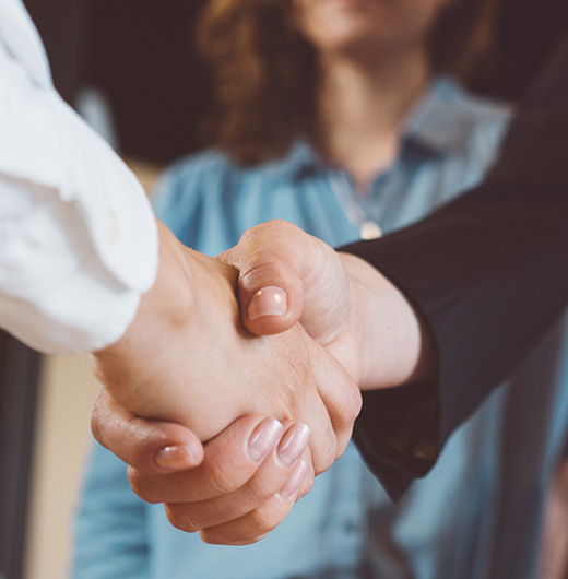 Photo of a hand shake between a woman and a man
